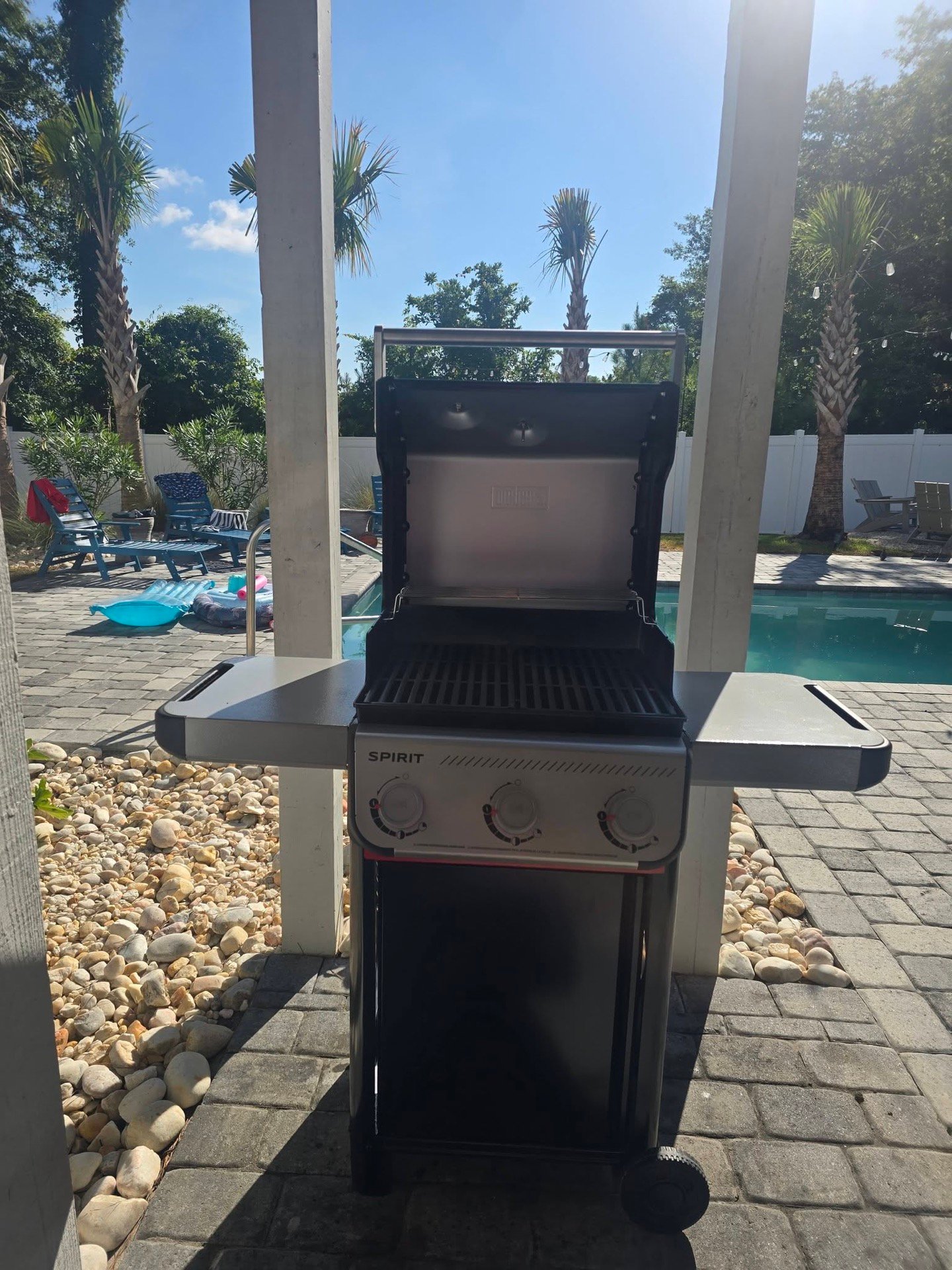 A Weber Spirit gas grill, freshly serviced, on a poolside patio in North Myrtle Beach